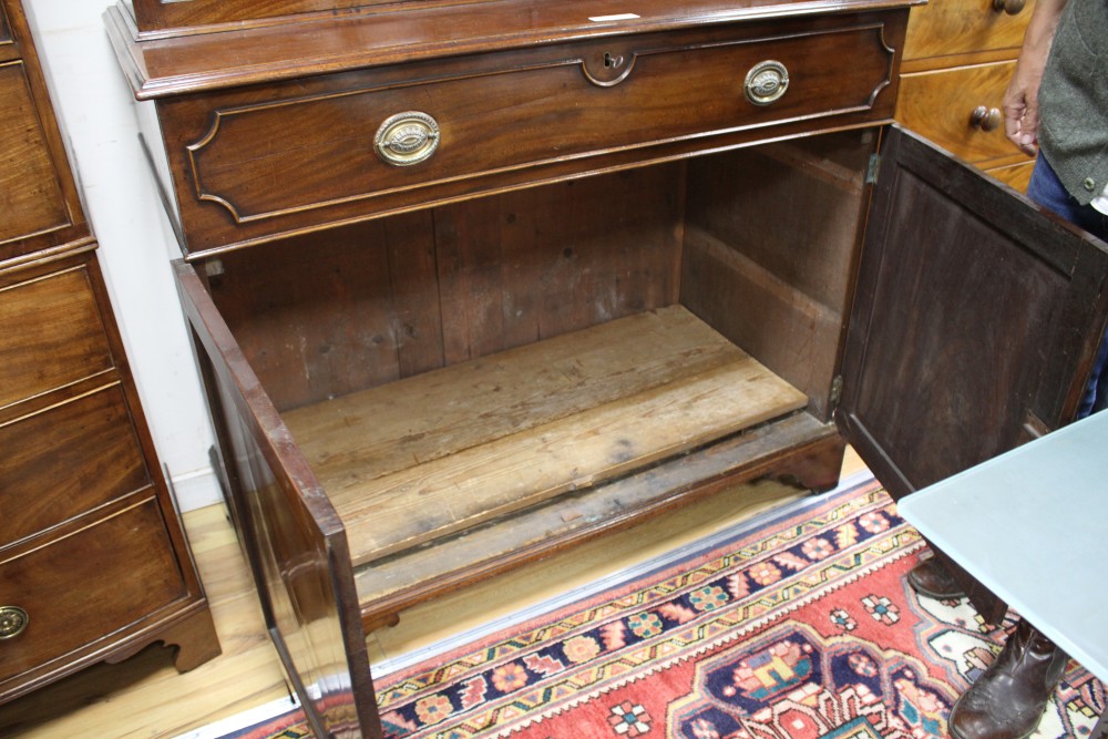 A George III style mahogany bookcase, with two astragal glazed doors over a fall front drawer and panelled doors, W.127cm D.62cm H.226c